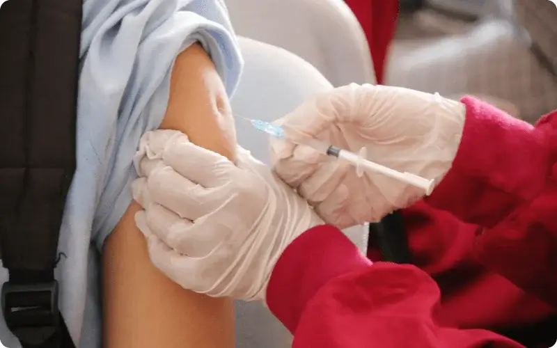 a teenager getting vaccinated with HPV vaccine